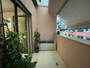 a room with a balcony with plants and a window at TAM Serviced 2BDR Apartment City Center No6 in Tirana