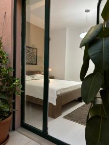 a bedroom with a bed and a mirror at TAM Serviced 2BDR Apartment City Center No6 in Tirana