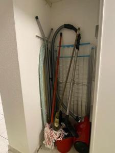 a bunch of gardening tools hanging on a wall at T2 5 Lys - centre ville, parking privé in Saint-Louis +9 photos