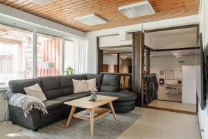 a living room with a couch and a table at Saxvikens vandrarhem in Mora
