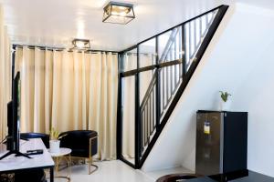 an office with a staircase and a desk with a computer at MilGees Vacation House in Cagayan de Oro
