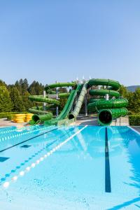 a large swimming pool with a water slide at Hotel Balnea Superior - Terme Krka in Dolenjske Toplice +125 photos
