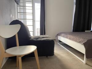 a bedroom with a bed and a chair and a table at Matty's in Olbia
