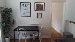 a dining room with a black table and white chairs at Private one room apartment in OLD TOWN in Stockholm