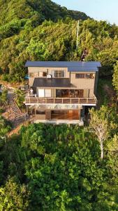 an aerial view of a house on a hill at IZU Elysian View in Koura