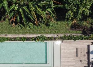 a fence with a green hedge on top of it at Sacred and Temple Bungalow in Canggu +62 photos