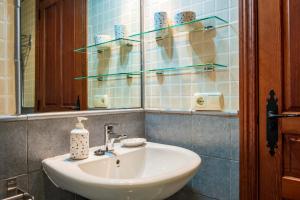 a bathroom with a white sink and a mirror at Casa Rural Doña Manuela in Valdemierque +27 photos