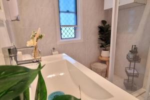 a bathroom with a white sink and a window at The Heavenly Haven in Brisbane +45 photos