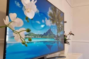a television screen with a picture of a beach at The Heavenly Haven in Brisbane