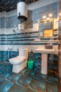 a bathroom with a toilet and a sink at Wood Crista Kufri near an Apple Orchard in Kūfrī +47 photos