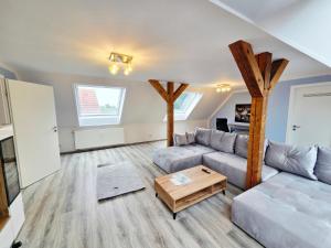 a living room with a couch and a table at Moritz Apartments - Apartment Pfarrgasse 11 - in Küllstedt