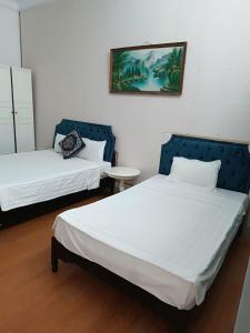 Postel nebo postele na pokoji v ubytování Hanoi Carina Hotel