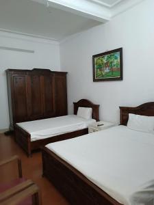 Voodi või voodid majutusasutuse Hanoi Carina Hotel toas