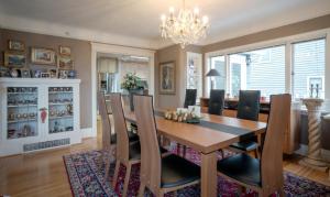 a dining room with a wooden table and chairs at Crystal's View Bed & Breakfast in North Vancouver