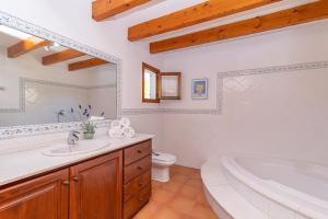 a bathroom with a tub and a toilet and a sink at Villa Pedra Vista by Sealand Villas in El Port +30 photos