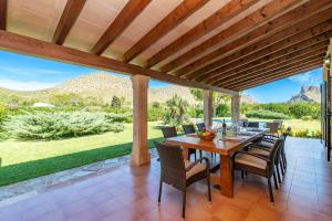 an outdoor dining room with a table and chairs at Villa Pedra Vista by Sealand Villas in El Port