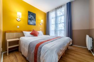 Un dormitorio con una cama grande y una ventana. en Disneyland Appartements familial avec piscine intérieur chauffé, parking gratuit A 5 minutes des parcs, en Serris
