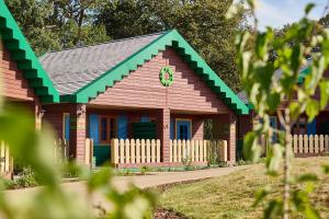 a small wooden house with a green roof at LEGOLAND(R) Windsor Resort in Windsor