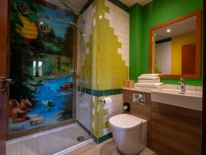 a bathroom with a shower and a toilet and a sink at LEGOLAND(R) Windsor Resort in Windsor