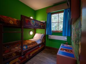a bedroom with two bunk beds and a window at LEGOLAND(R) Windsor Resort in Windsor