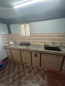 a kitchen with a sink and a counter top at Serenity Homestay Shillong in Shillong