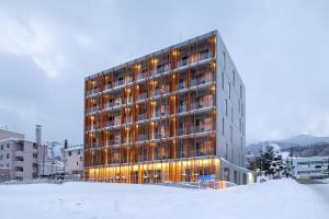 富良野Fenix West的雪中建筑物,灯光照亮