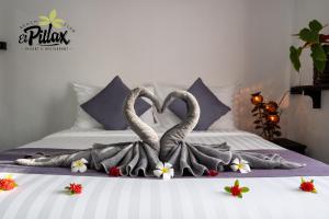 two swans are making a heart shape on a bed at Villa - Sleeps 8 - Terrace - Beach Close in Ko Lanta
