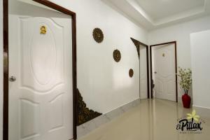 a hallway with a white door and a mirror at Villa - Sleeps 8 - Terrace - Beach Close in Ko Lanta