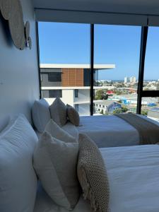 a bedroom with two beds and a large window at Sunshine Coast Paradise in Maroochydore +44 photos
