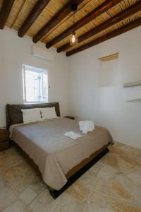 a bedroom with a large bed in a white room at Dipaton House in Vasa 1 in Limassol