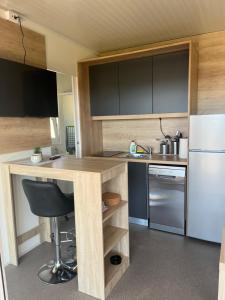 a small kitchen with a desk and a refrigerator at Mobile homes Tina Pakoštane in Pakoštane +6 photos