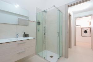 a bathroom with a glass shower and a sink at Casa rossoblu - zona stadio in Bologna +19 photos