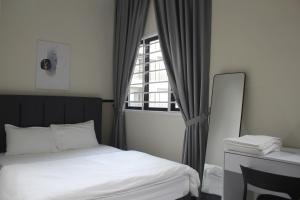 a bedroom with a bed and a window at NYC residence Nilai Youth City in Nilai +7 photos