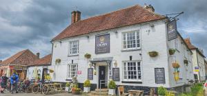 a white building with bikes parked outside of it at The Crown Aldbourne in Aldbourne