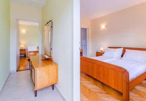 a bedroom with a bed and a mirror at House Dinko in Vinišće