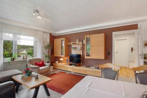 a living room with a couch and a television at Birkenhauer inkl Meine Card plus in Willingen