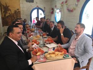 a group of men sitting at a long table at Motel EL Golla 