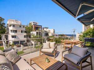 a patio with chairs and a table on a balcony at Miami Getaway in Gold Coast