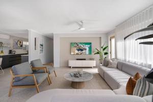 a living room with a couch and a table at Miami Getaway in Gold Coast