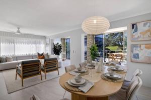 a dining room and living room with a table and chairs at Miami Getaway in Gold Coast