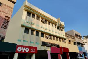 a building with a hotel sign in front of it at Hotel O Arjun in Prayagraj