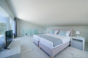 Posteľ alebo postele v izbe v ubytovaní Hotel ASTERA