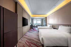 Postel nebo postele na pokoji v ubytování Mövenpick by Accor Xuzhou