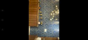 a kitchen with a wall with blue tiles and a cabinet at Flat in Visakhapatnam in Visakhapatnam