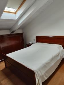 a bedroom with a large bed with white sheets at Porta di Oriente Ca' di lenzi in Ravenna