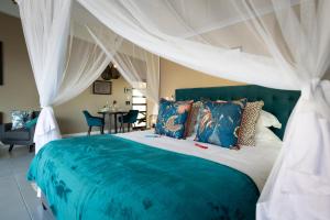 a bedroom with a blue and white bed with curtains at Marepe Mountain View - Private villa with pool and unrivalled views in Kampersrus AH +88 photos