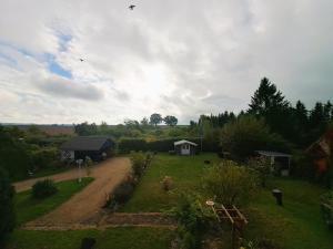 a view of a garden with a house and a field at Ferienwohnung "Weit Blick" Objekt-ID 15678-6 in Neu Schloen