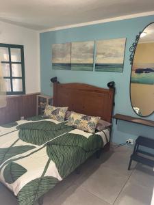 two beds in a room with a mirror at Apartamento Los Lagos Renovated New Kitchen & More in El Cotillo