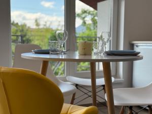 a table with chairs and glasses on top of it at SoNa apartments in Berehove