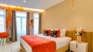 a bedroom with a bed with a vase of flowers on it at Arts by Loulé - Alojamento de Charme in Loulé